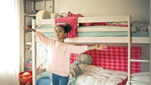 Little girl standing up with arms wide open