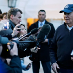 President Biden surrounded by reporters and photographers.