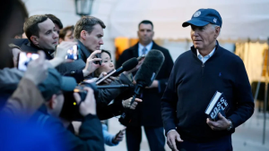 President Biden surrounded by reporters and photographers.