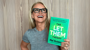 Mel Robbins with her book, the LET THEM Theory
