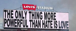 A billboard with the line 'The only thing more powerful than hate is love.'