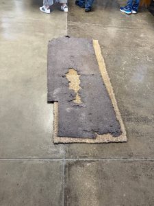 One hard mat, one soft mat. Concrete floor.